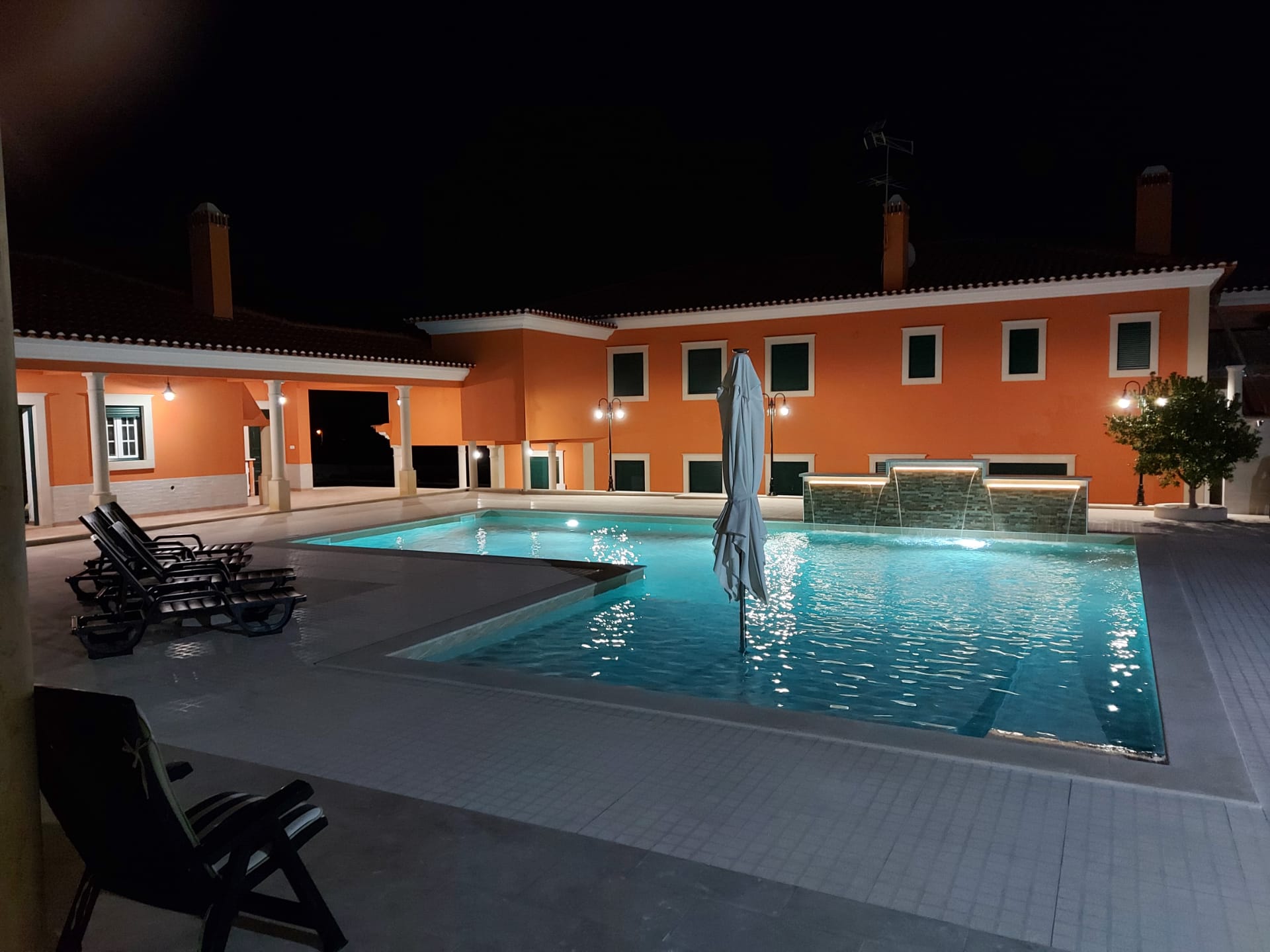Outdoor pool with illuminated water features at Solar do Sal boutique hotel near Salinas de Rio Maior
