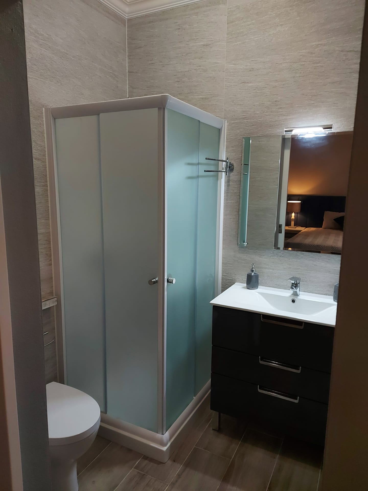 Two-bedroom apartment bathroom with glass shower