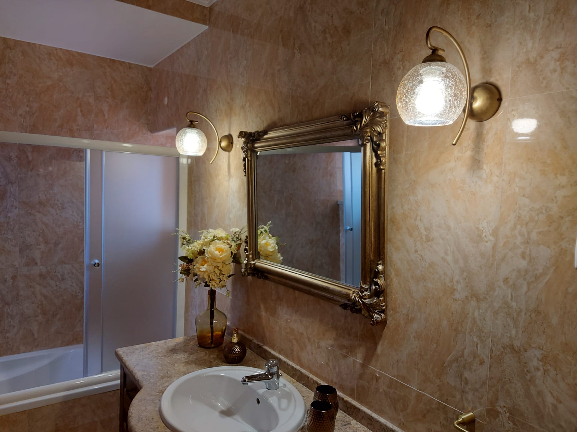 Bathroom with gilded mirror