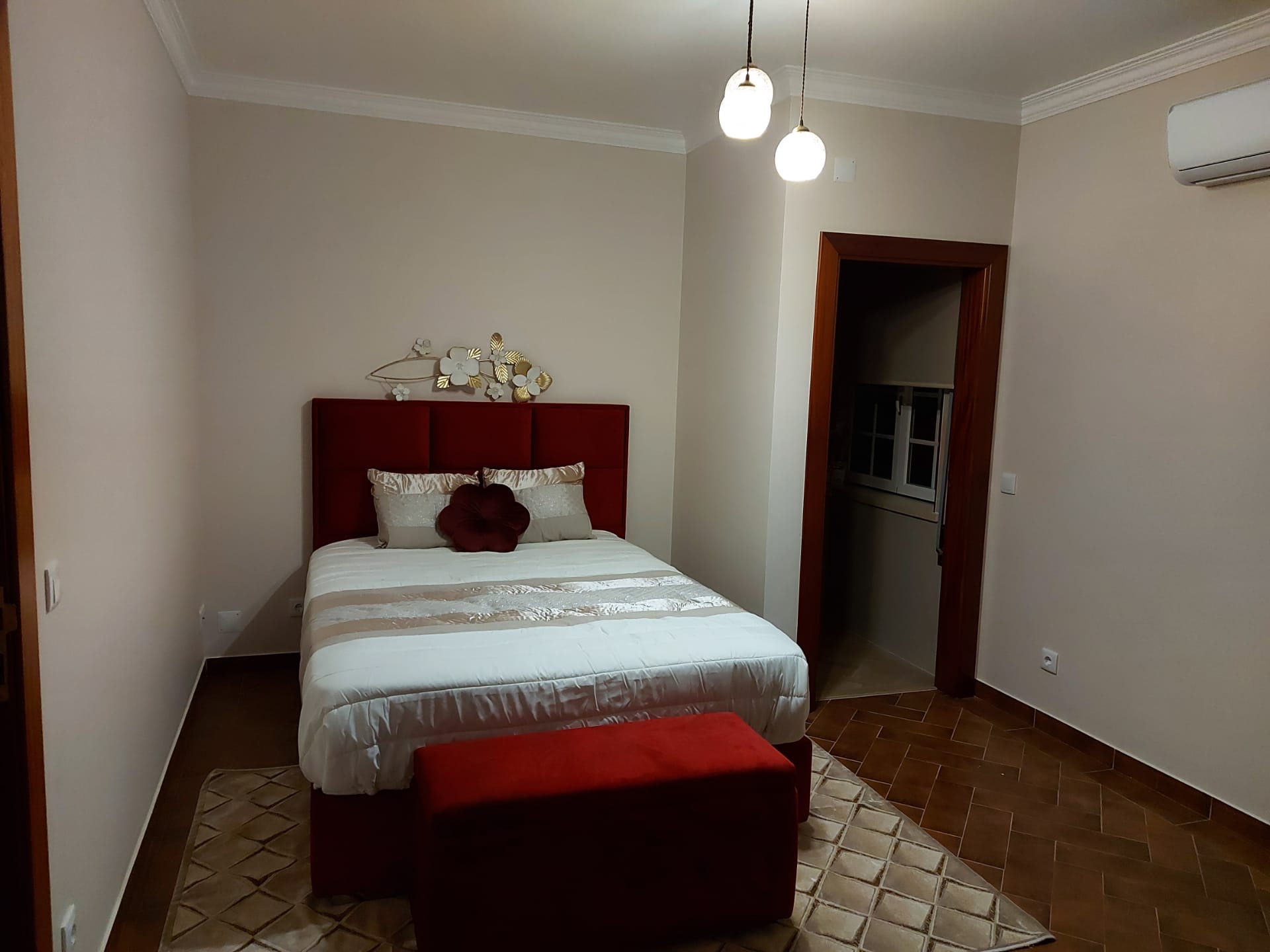 Double room with red headboard