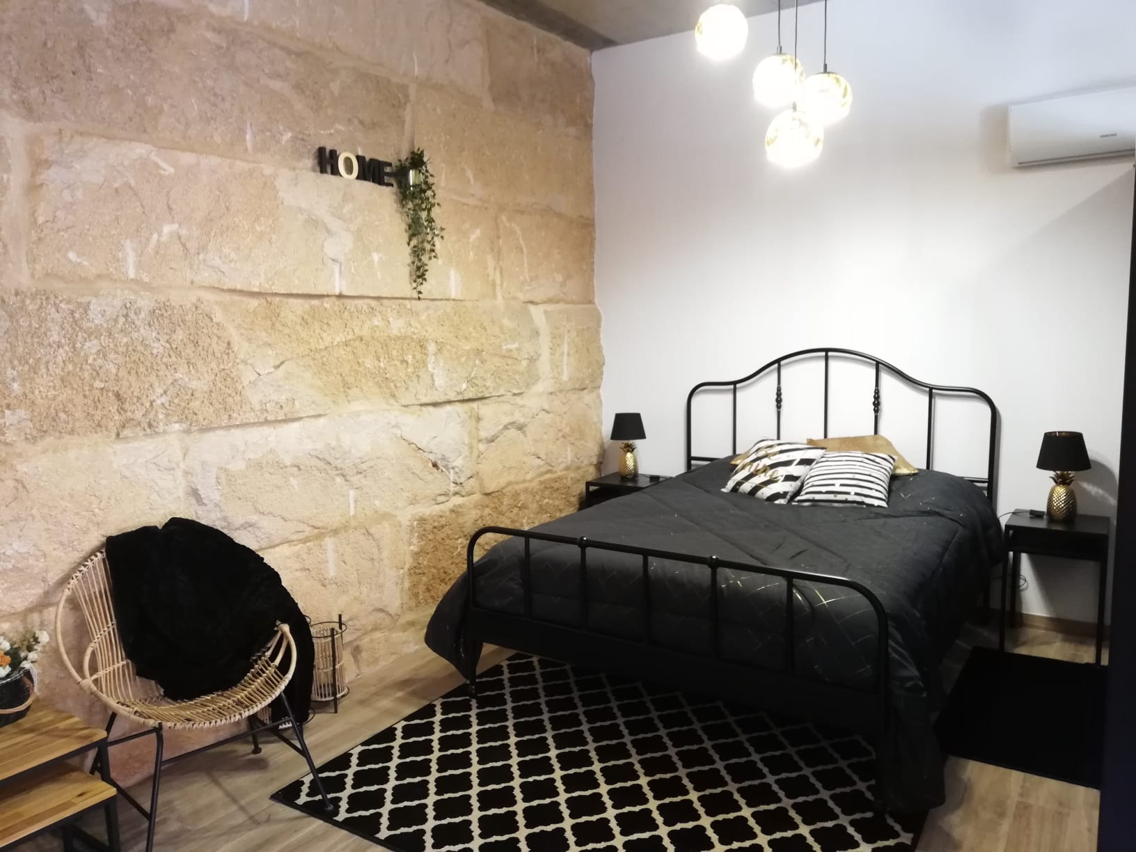 Double room with exposed stone wall